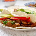 Carnitas served inside a wheat tortilla.