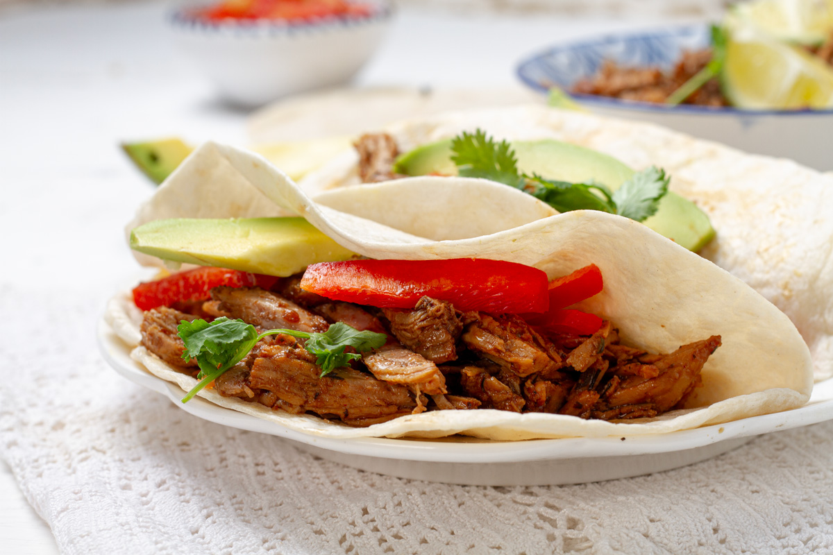 Carnitas served inside a wheat tortilla.