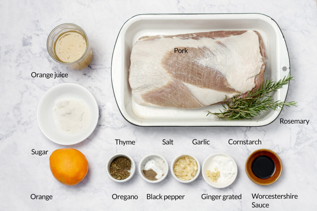 Everything you need for a flavorful orange pork loin – fresh citrus, spices, herbs, and pork, ready to come together in a delicious, slow-cooked dish.