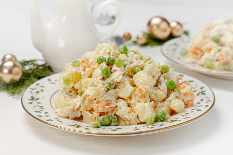 Traditional Venezuelan Ensalada de Gallina, creamy chicken salad, garnished with peas.