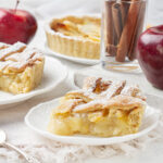 A delicious-looking apple pie with a lattice crust, sprinkled with powdered sugar.