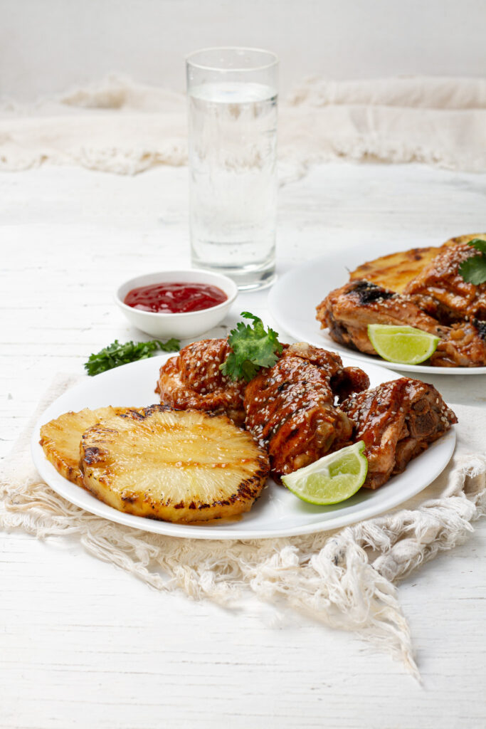  A sizzling plate of Huli Huli chicken and grilled pineapple, marinated in a sweet and savory sauce. The perfect dish for a Hawaiian-themed barbecue.